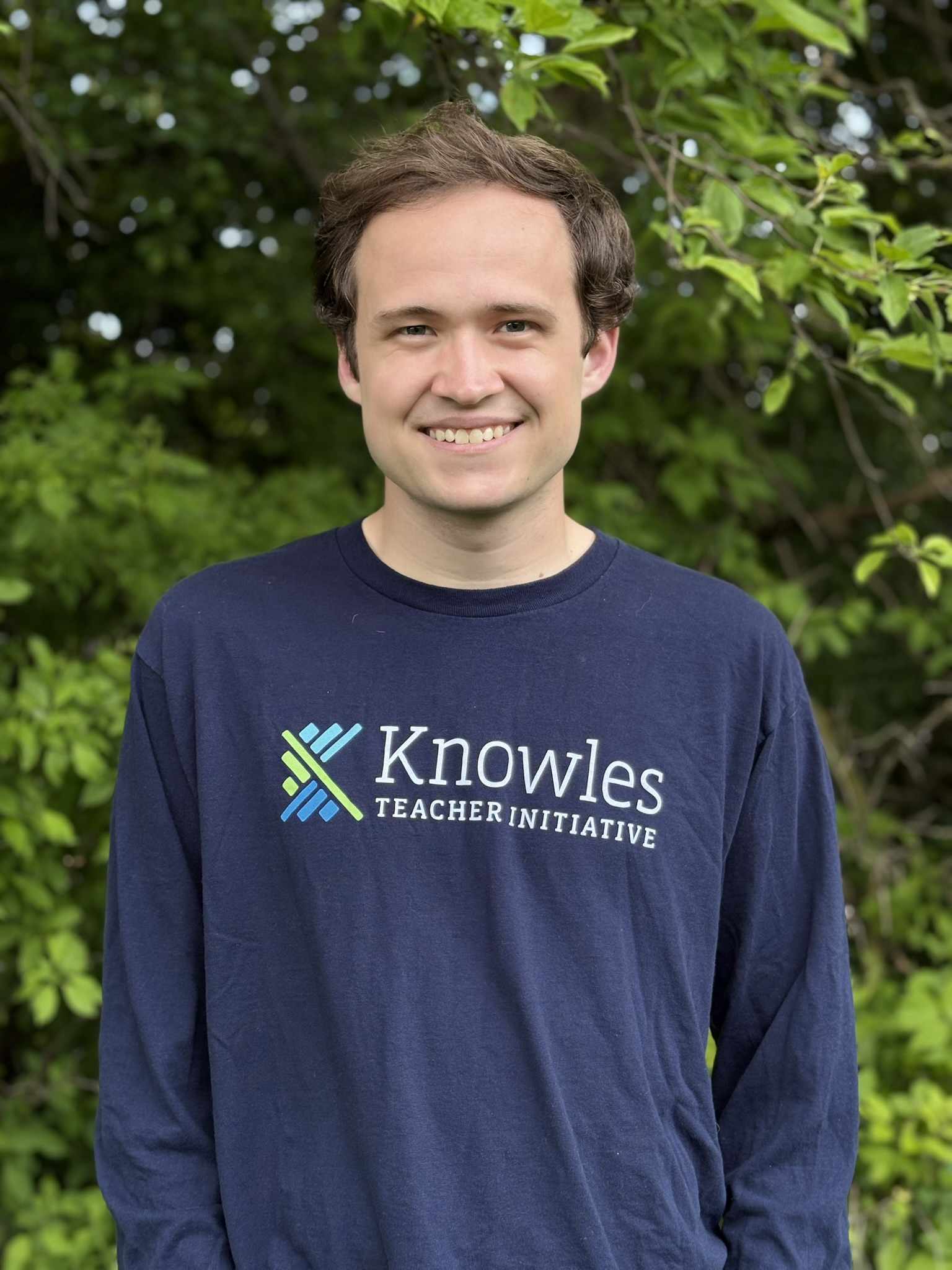 Josh Pullen standing in front of a background of trees