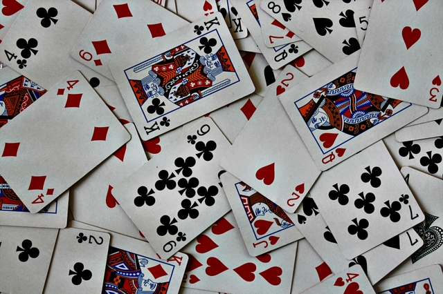 A deck of cards scattered on a table.